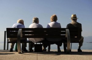 View taken on Oktober 6, 2008 shows elderly people sitting on a bench facing the Lake Garda in Bardolino, northern Italy. The Garda Lake is the largest Italian lake, situated at the foot of the Alps and is a major tourist destination. AFP PHOTO DDP/ OLIVER LANG GERMANY OUT (Photo credit should read OLIVER LANG/AFP/Getty Images)